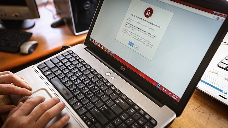 Image of a technician removing a computer virus by running a scan